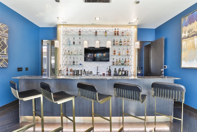 bar featuring dark hardwood / wood-style flooring