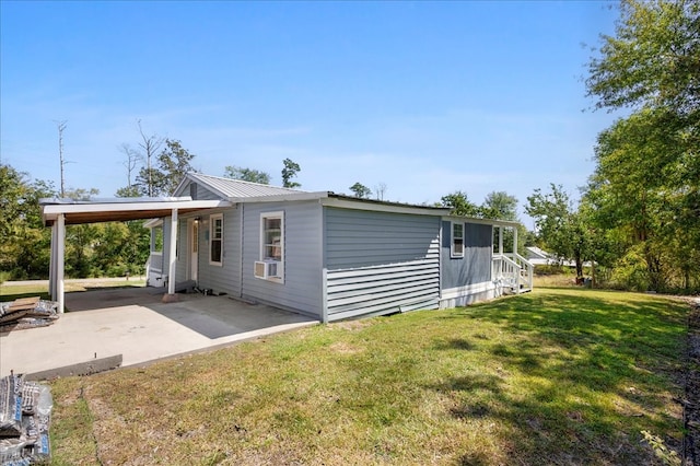 view of side of property with a yard and a carport