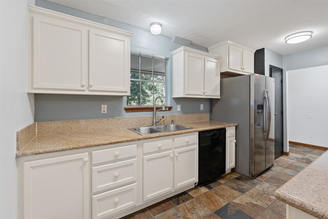 kitchen featuring stainless steel fridge, white cabinetry, black dishwasher, and sink