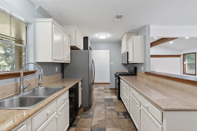 kitchen featuring white cabinetry, black appliances, sink, and a wealth of natural light