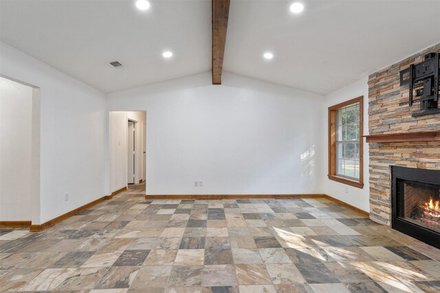 unfurnished living room featuring a stone fireplace and vaulted ceiling with beams