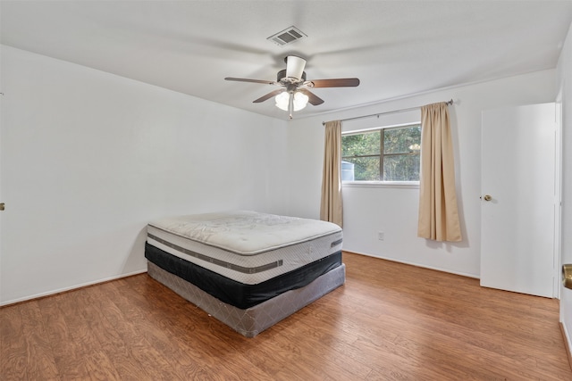 bedroom with hardwood / wood-style flooring and ceiling fan