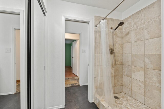 bathroom featuring a shower with curtain and concrete flooring