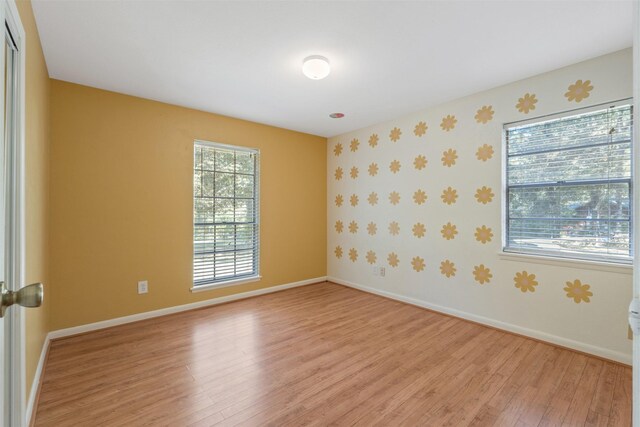 spare room featuring light hardwood / wood-style floors