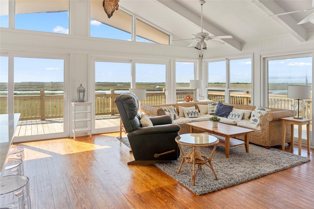 1304 N Tinkle Ln, Crystal Beach, TX 77650 - sunroom with hardwood / wood-style floors, lofted ceiling with beams, and a deck with water view