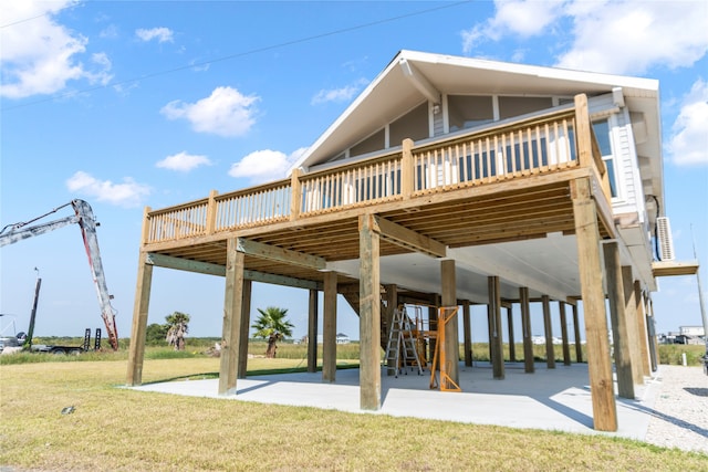 view of home's community featuring a wooden deck, a patio area, and a lawn