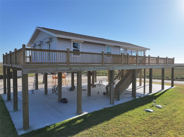 exterior space featuring a wooden deck and a lawn