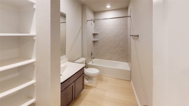 full bathroom with vanity, tiled shower / bath combo, and toilet