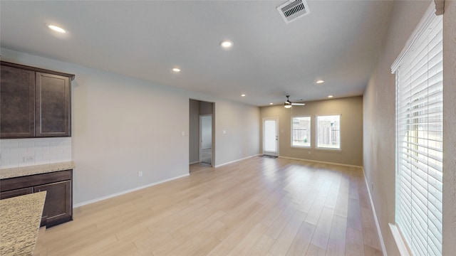 unfurnished living room with light hardwood / wood-style floors and ceiling fan