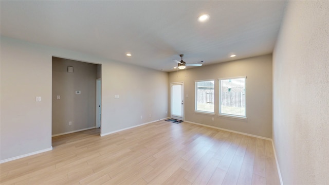 unfurnished room with light wood-type flooring and ceiling fan