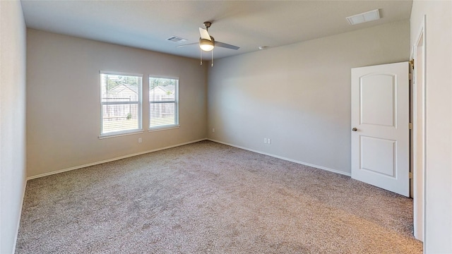 carpeted spare room with ceiling fan