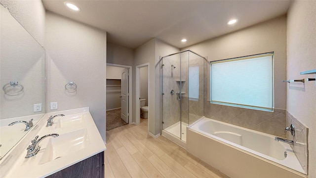 full bathroom with vanity, hardwood / wood-style floors, plus walk in shower, and toilet