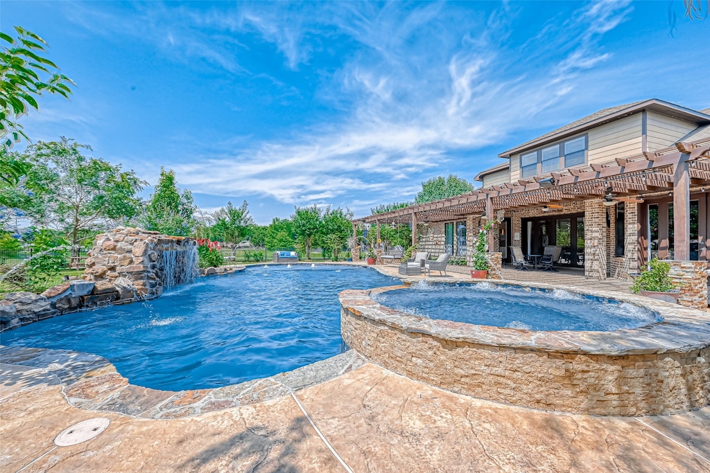 view of pool with pool water feature, a patio area, a pergola, and an in ground hot tub