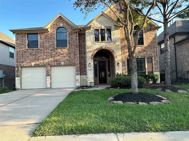 view of front of home featuring driveway, stone siding, an attached garage, a front lawn, and brick siding