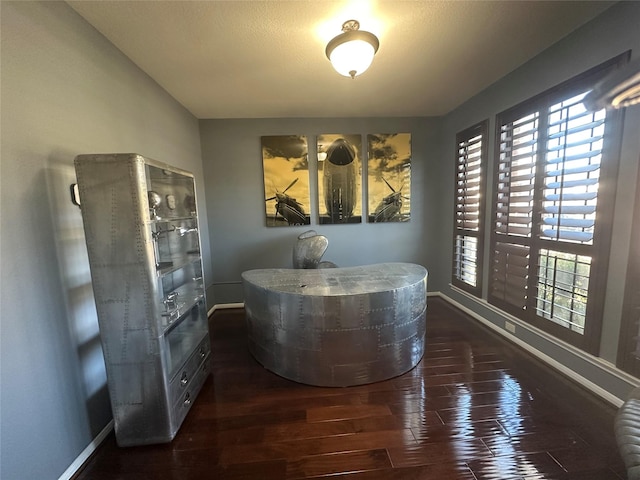 interior space featuring dark wood finished floors and baseboards