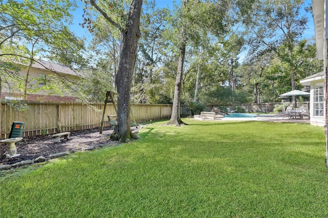 view of yard with a patio area and a fenced in pool