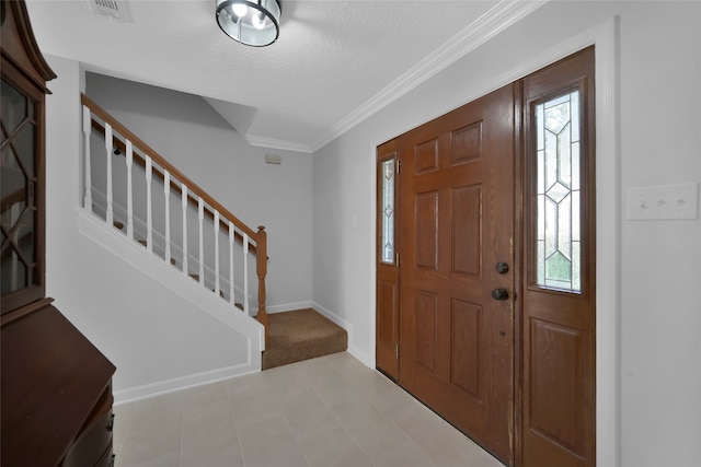 entrance foyer with crown molding and a textured ceiling