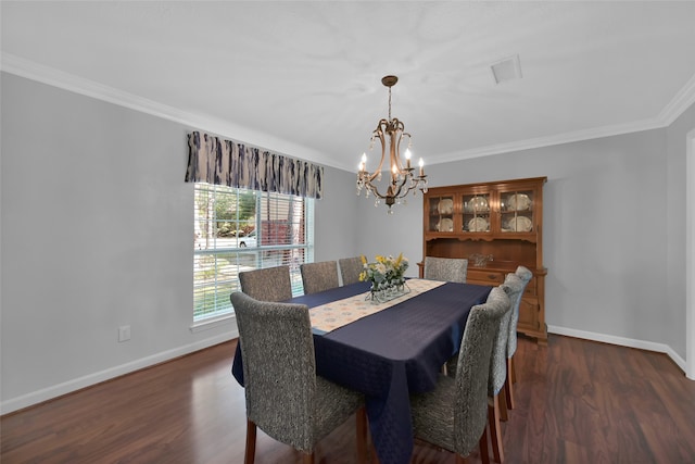 dining area featuring an inviting chandelier, crown molding, and dark wood-type flooring