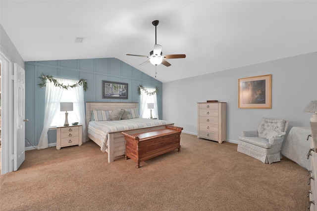 carpeted bedroom with ceiling fan, multiple windows, and vaulted ceiling