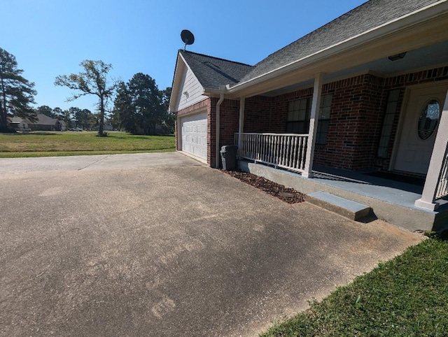 view of home's exterior with a porch and a lawn