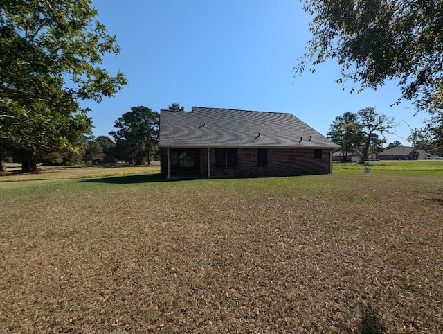 rear view of house with a yard