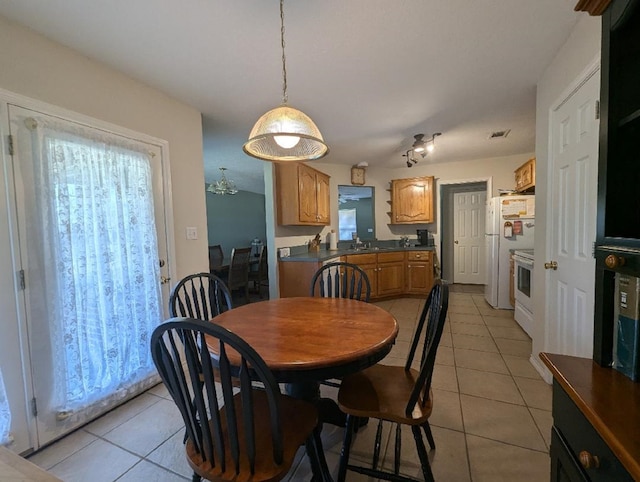 tiled dining space featuring sink