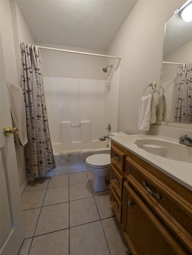 full bathroom with a textured ceiling, toilet, shower / bath combo with shower curtain, vanity, and tile patterned floors