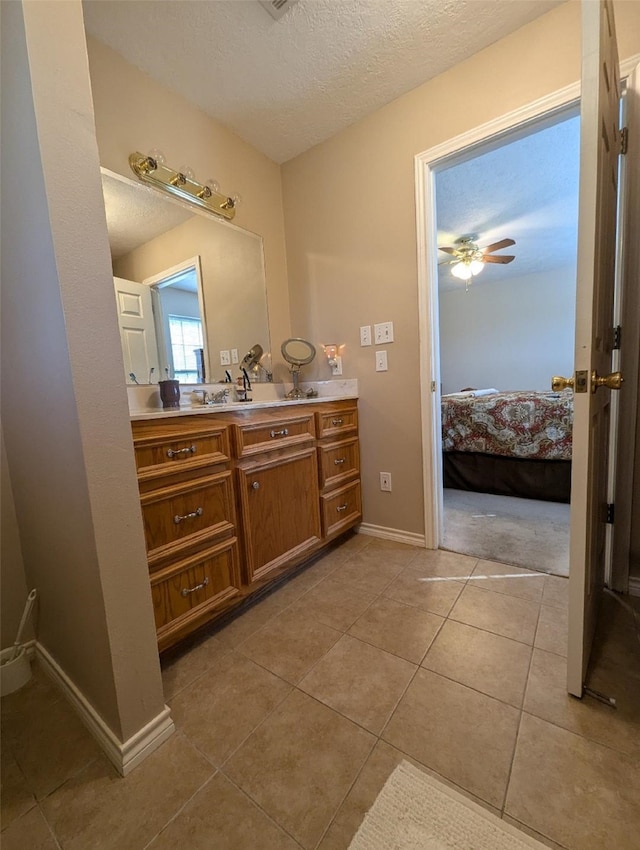 bathroom featuring vanity, a textured ceiling, ceiling fan, and tile patterned flooring