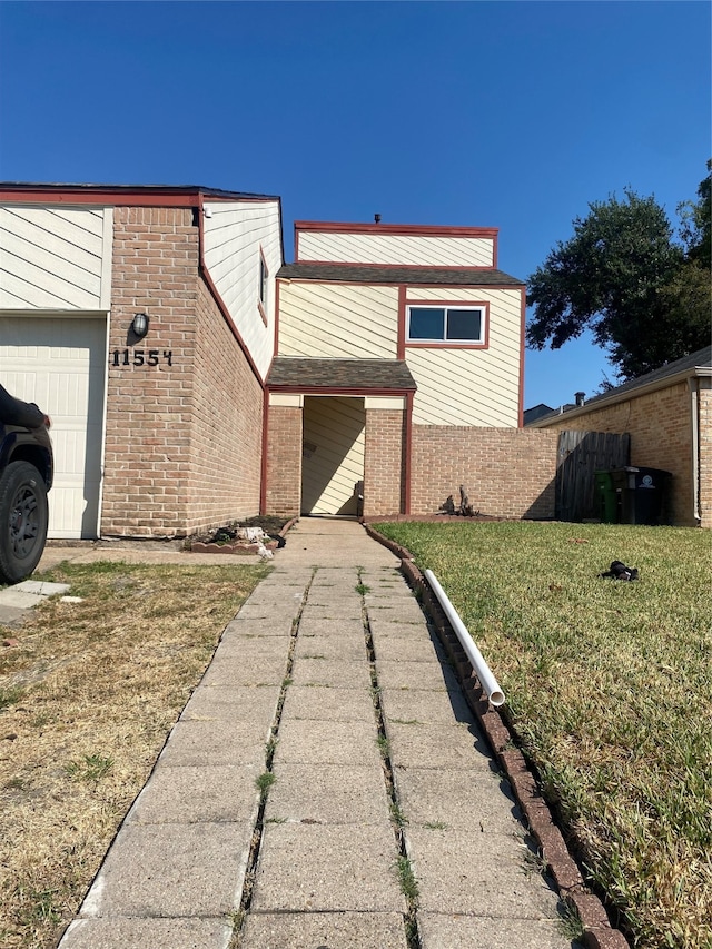 view of front of house with a front yard and a garage