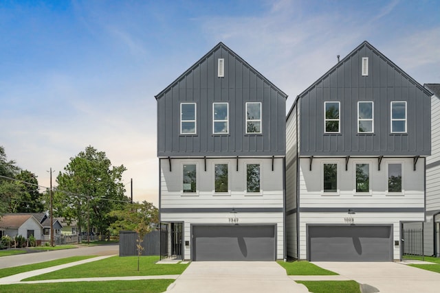 modern farmhouse featuring a front yard and a garage