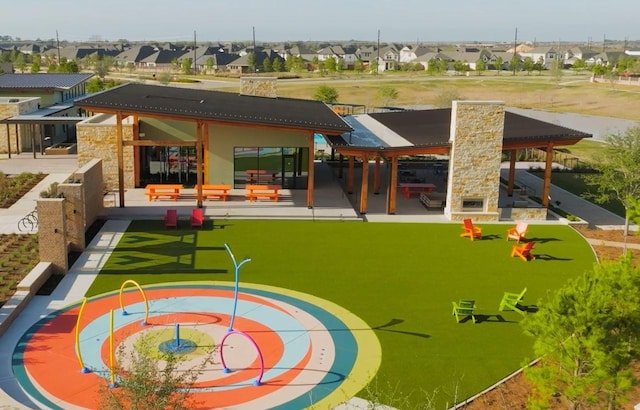 view of playground with a residential view and a fireplace