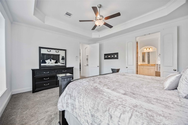 bedroom featuring a tray ceiling, crown molding, visible vents, light carpet, and baseboards