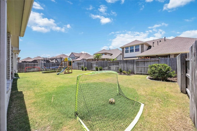 view of yard featuring a trampoline, a playground, a fenced backyard, and a residential view