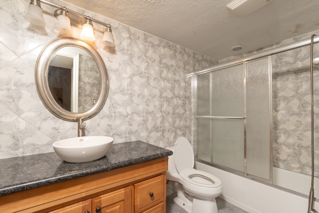 full bathroom featuring vanity, toilet, tile walls, and enclosed tub / shower combo