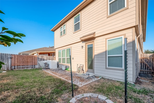 back of property featuring a patio and a lawn