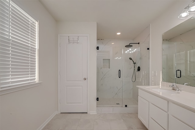 bathroom with a shower with door and vanity