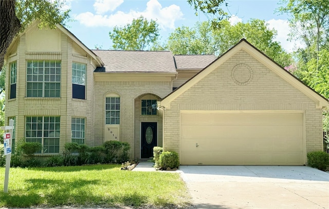 view of front of home with a garage and a front lawn