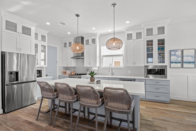 26831 Bay Water Dr, Galveston, TX 77554 - kitchen with light countertops, stainless steel appliances, a sink, and a center island