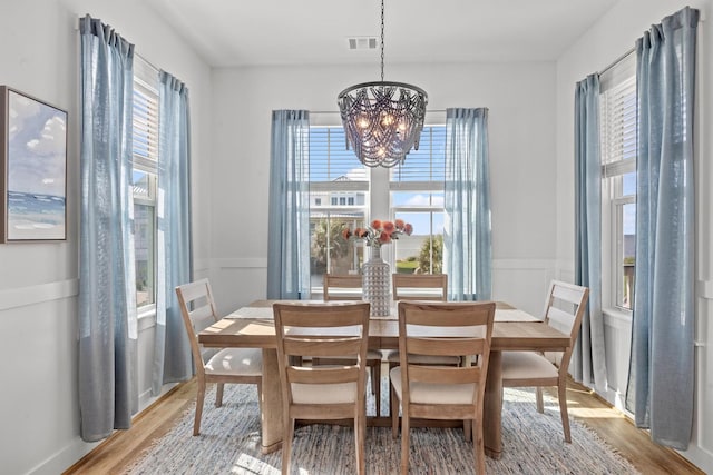 26831 Bay Water Dr, Galveston, TX 77554 - dining area featuring a notable chandelier, visible vents, and wood finished floors