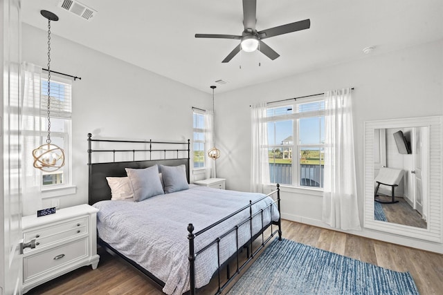 26831 Bay Water Dr, Galveston, TX 77554 - bedroom featuring ceiling fan, wood finished floors, and visible vents
