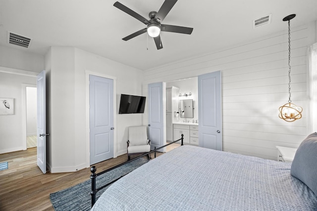 26831 Bay Water Dr, Galveston, TX 77554 - bedroom with baseboards, visible vents, wood finished floors, and ensuite bathroom