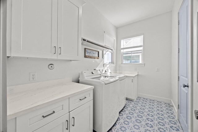 26831 Bay Water Dr, Galveston, TX 77554 - laundry area featuring cabinet space, baseboards, washer and clothes dryer, and light floors