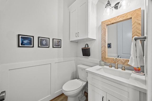 26831 Bay Water Dr, Galveston, TX 77554 - half bath with a wainscoted wall, vanity, toilet, and a decorative wall
