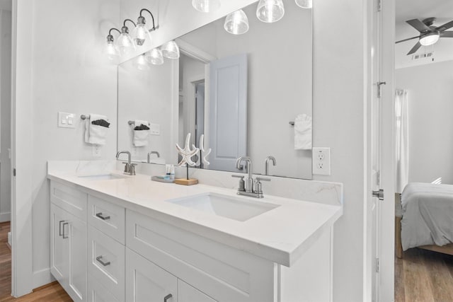 26831 Bay Water Dr, Galveston, TX 77554 - bathroom with a sink, a ceiling fan, wood finished floors, and connected bathroom