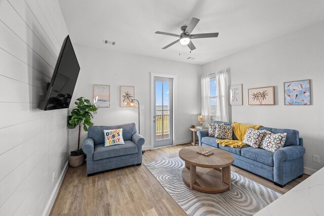 26831 Bay Water Dr, Galveston, TX 77554 - living area featuring baseboards, ceiling fan, visible vents, and wood finished floors