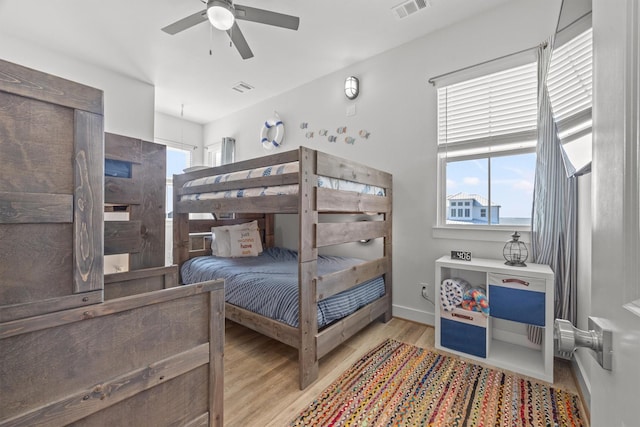 26831 Bay Water Dr, Galveston, TX 77554 - bedroom featuring visible vents, a ceiling fan, baseboards, and wood finished floors