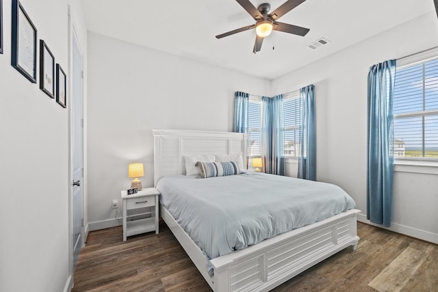 26831 Bay Water Dr, Galveston, TX 77554 - bedroom with dark wood-style flooring, baseboards, visible vents, and a ceiling fan