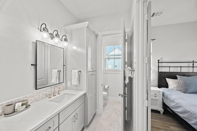 26831 Bay Water Dr, Galveston, TX 77554 - full bath with vanity, marble finish floor, toilet, and visible vents