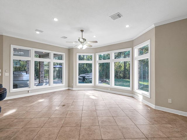 interior space with crown molding, visible vents, and a wealth of natural light