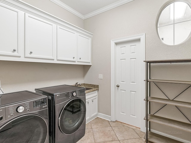 clothes washing area featuring cabinet space, ornamental molding, separate washer and dryer, a sink, and light tile patterned flooring